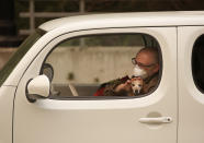 <p>Chris Shiery pets his dog, Ruby, while waiting to evacuate the town of Sonoma, Calif., on Oct. 11, 2017. For many residents in the path of one of California’s deadliest blazes, talk is of wind direction, evacuations and goodbyes. (Photo: Rich Pedroncelli/AP) </p>