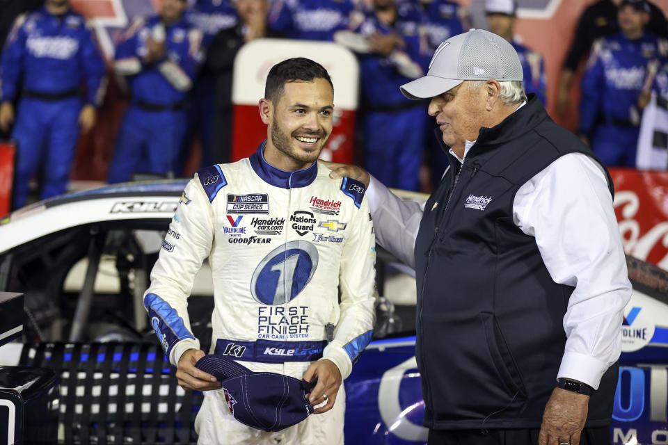 FILE - Car owner Rick Hendrick, right, congratulates Kyle Larson in victory lane after Larson won the NASCAR Cup Series auto race at Charlotte Motor Speedway in Concord, N.C., Sunday, May 30, 2021. Kyle Larson will attempt to race the Indianapolis 500 in 2024 with McLaren Racing in a joint effort with NASCAR team owner Rick Hendrick. The surprise Thursday, Jan. 12, 2023, announcement by McLaren and Hendrick at last gives Larson a path into his dream race.(AP Photo/Nell Redmond, File)