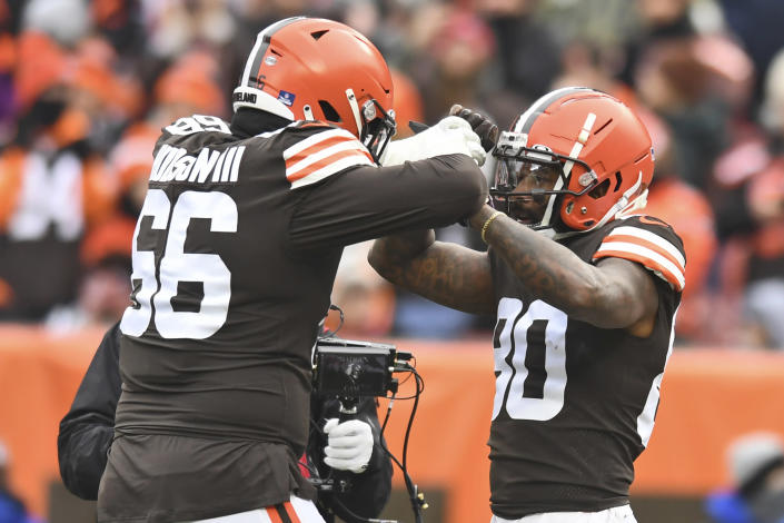 Cleveland Browns wide receiver Jarvis Landry (80) celebrates a 26-yard touchdown with offensive tackle James Hudson (66) during the first half of an NFL football game against the Cincinnati Bengals, Sunday, Jan. 9, 2022, in Cleveland. (AP Photo/Nick Cammett)