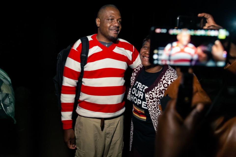 Zimbabwean journalist Hopewell Chin'ono is embraced by a supporter following speaking to the press after his release on bail from Chikurubi Maximum Prison in Harare, on September 2, 2020.<span class="copyright">JEKESAI NJIKIZANA/AFP via Getty Images</span>