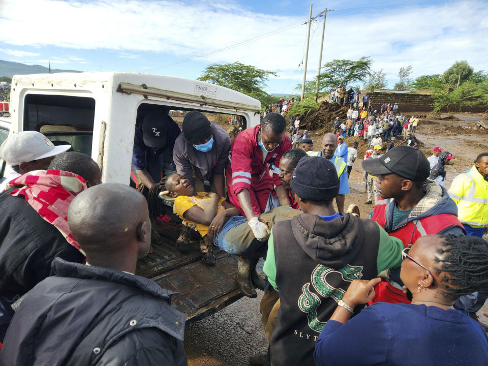 Paramedics carry an injured woman after a dam burst, in Kamuchiri Village Mai Mahiu, Nakuru County, Kenya, Monday, April. 29, 2024. Police in Kenya say at least 40 people have died after a dam collapsed in the country's west. (AP Photo)