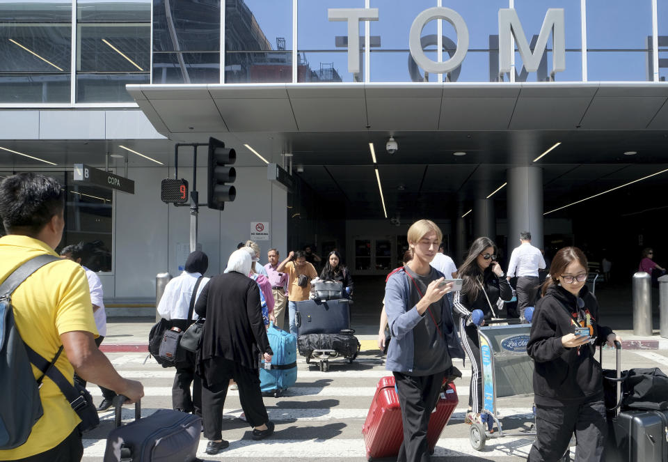 Travelers maneuver in and out of the Tom Bradley International Terminal at LAX on Wednesday, Aug. 30, 2023, in Los Angeles. With Labor Day weekend just days away, airports and roadways are expected to be busy as tens of thousands of Southern Californians travel out of town. (Dean Musgrove/The Orange County Register via AP)