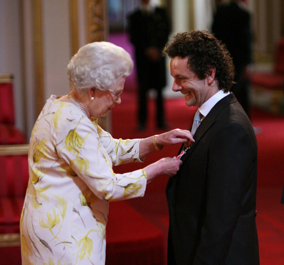 Actor Michael Sheen receives an OBE from Queen Elizabeth II during investitures at Buckingham Palace.