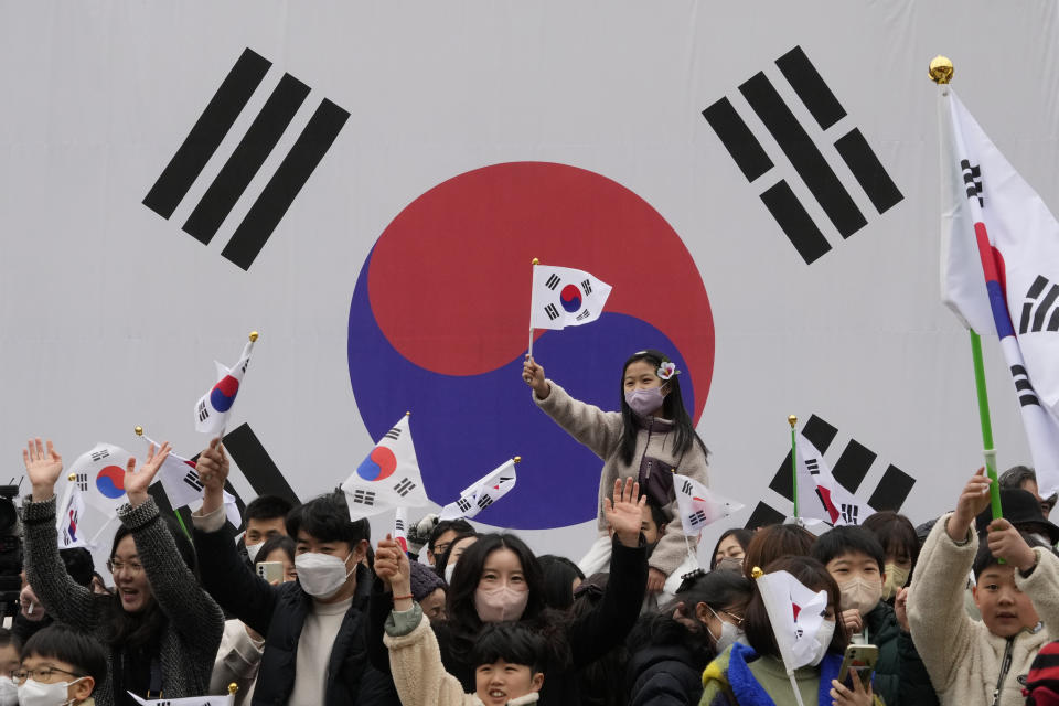 South Koreans wave national flags during a ceremony to celebrate the March First Independence Movement Day, the anniversary of the 1919 uprising against Japanese colonial rule, in Seoul, South Korea, Wednesday, March 1, 2023. (AP Photo/Ahn Young-joon)