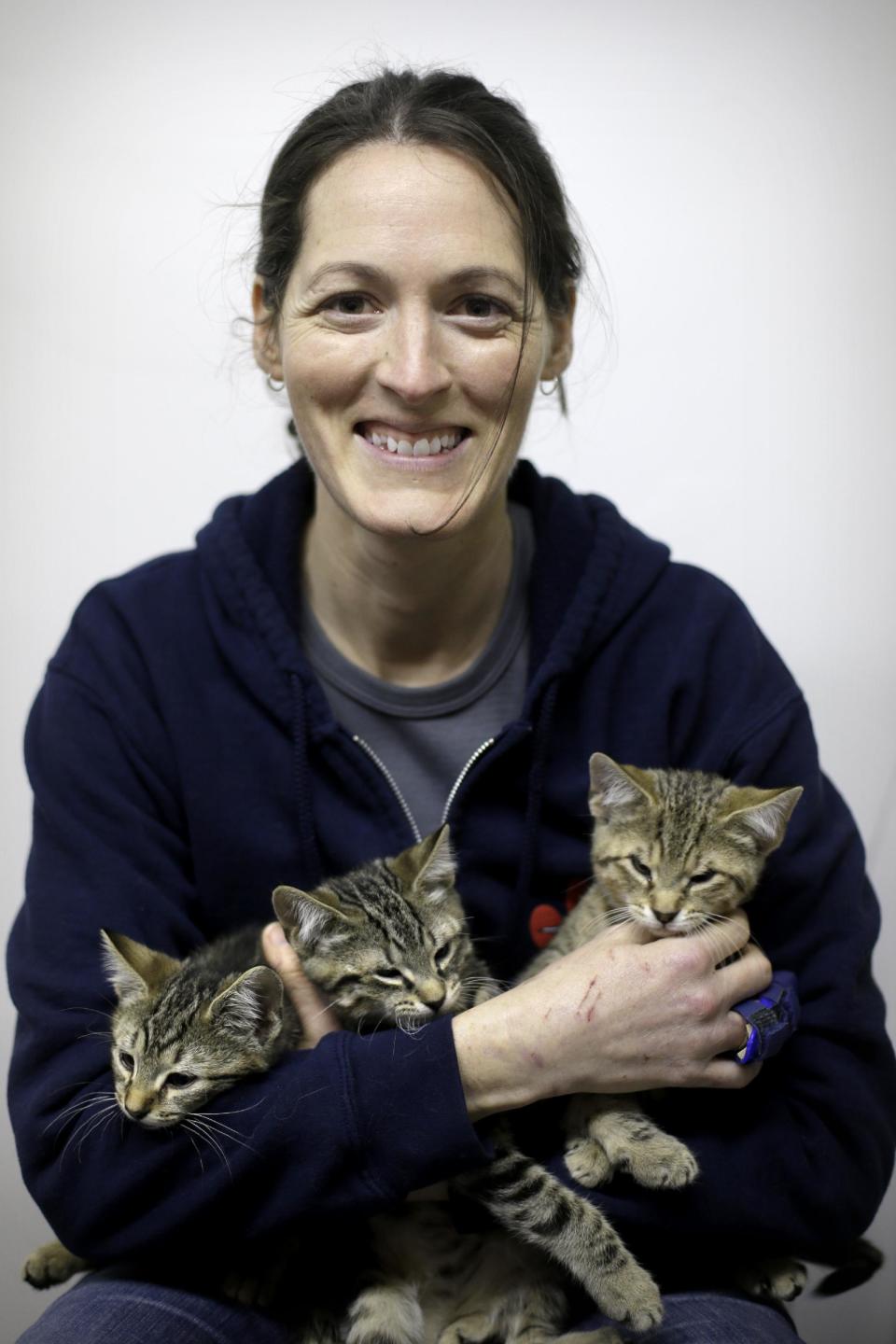 In this Thursday, March 28, 2013 photo, Red Paw founder Jen Leary poses for a portrait at their adoption facility in Philadelphia, with kittens displaced due to fires. The emergency relief service Red Paw has paired with the local Red Cross to care for animals displaced by flames, floods or other residential disasters, with the goal of eventually reuniting them with their owners. (AP Photo/Matt Rourke)