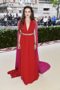 <p>Representing Australia in this Prada red and pink cape dress, Katherine Langford made her debut on the Met Gala red carpet. Photo: Getty Images </p>