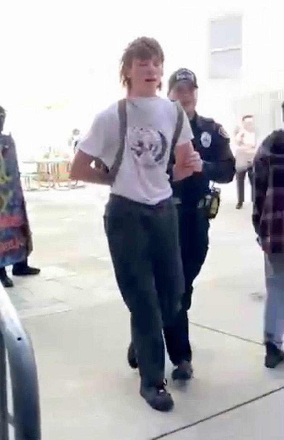 A San Luis Obispo police officer arrests a protester during an pro-Palestine demonstration at Cal Poly on Jan. 23, 2024.