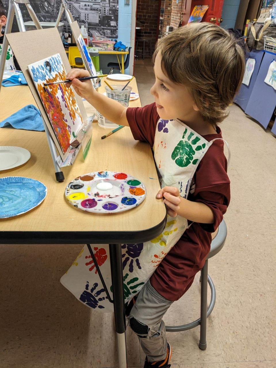 A young student paints at Wayne Center for the Arts.