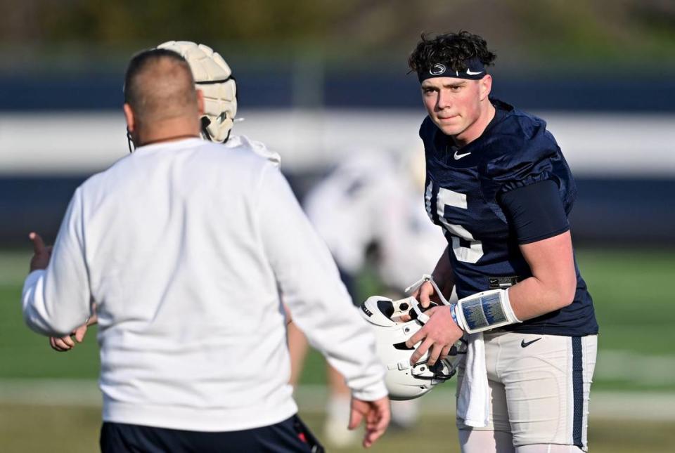 Quarterback Drew Allar listens to offensive coordinator Andy Kotelnicki during Penn State football spring practice on Tuesday, March 12, 2024.