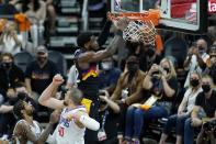 Phoenix Suns center Deandre Ayton, right, dunks as he gets past Los Angeles Clippers center Ivica Zubac (40) and guard Paul George, left, during the second half of Game 1 of the NBA basketball Western Conference finals Sunday, June 20, 2021, in Phoenix. (AP Photo/Ross D. Franklin)