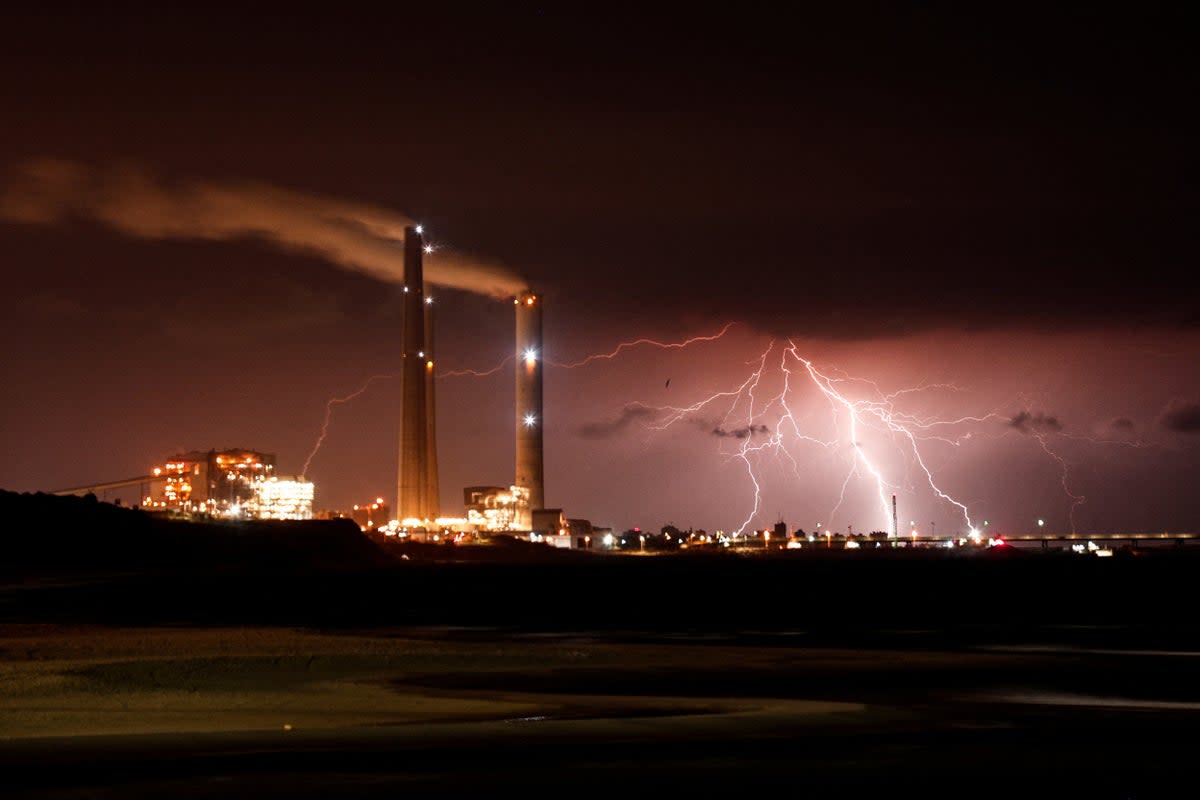 Rutenberg power station is seen as lightning strikes over the Mediterranean sea at the coastal city of Ashkelon, Israel (Reuters)