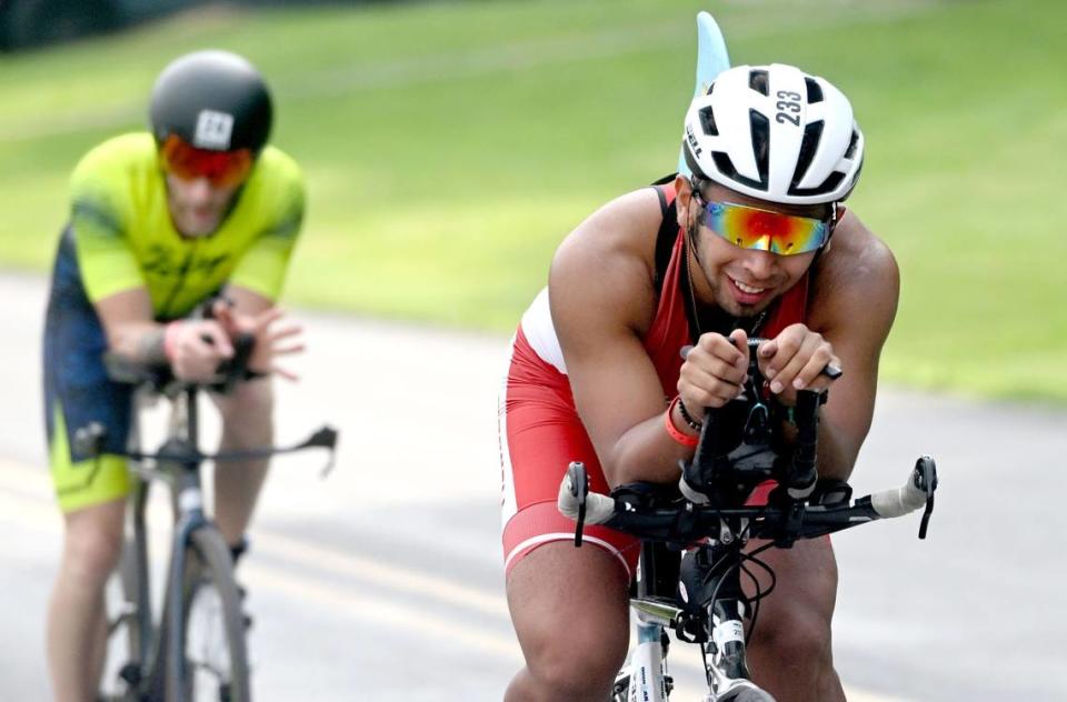 Cyclists smile as they are cheered on by community members along Jacksonville Road during the Ironman 70.3 Pennsylvania Happy Valley on Sunday, June 30, 2024.