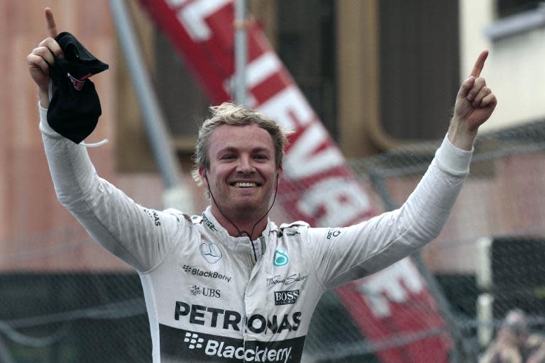 Mercedes AMG Petronas F1 Team's German driver Nico Rosberg celebrates winning in the parc ferme at the Monaco street circuit in Monte-Carlo on May 24, 2015, during the Monaco Formula One Grand Prix