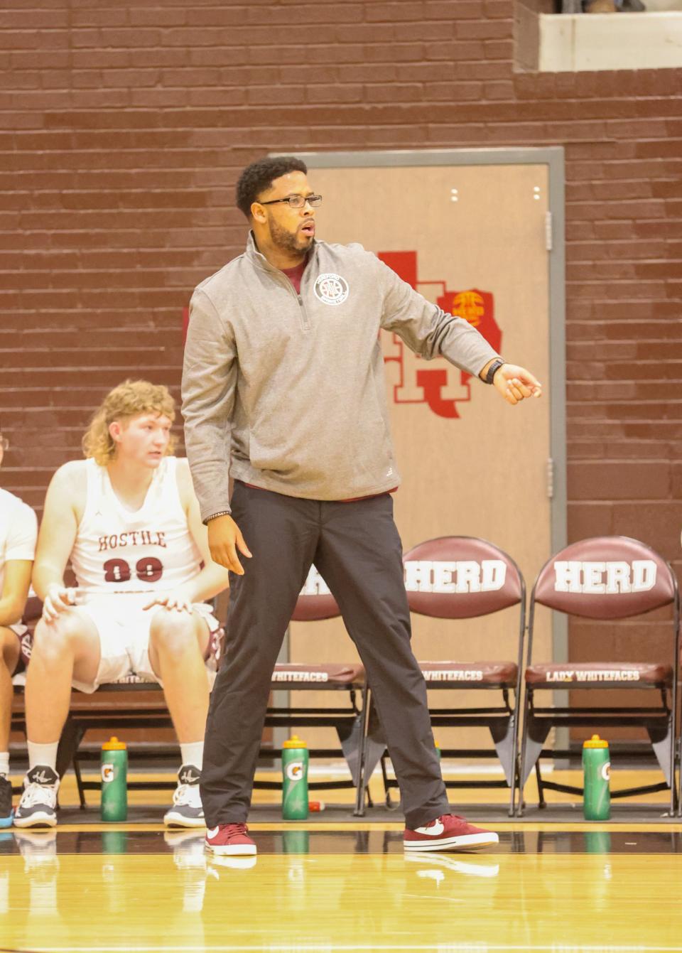 Marques Loftis observes the Hereford boys basketball team during a game in the 2022 season.