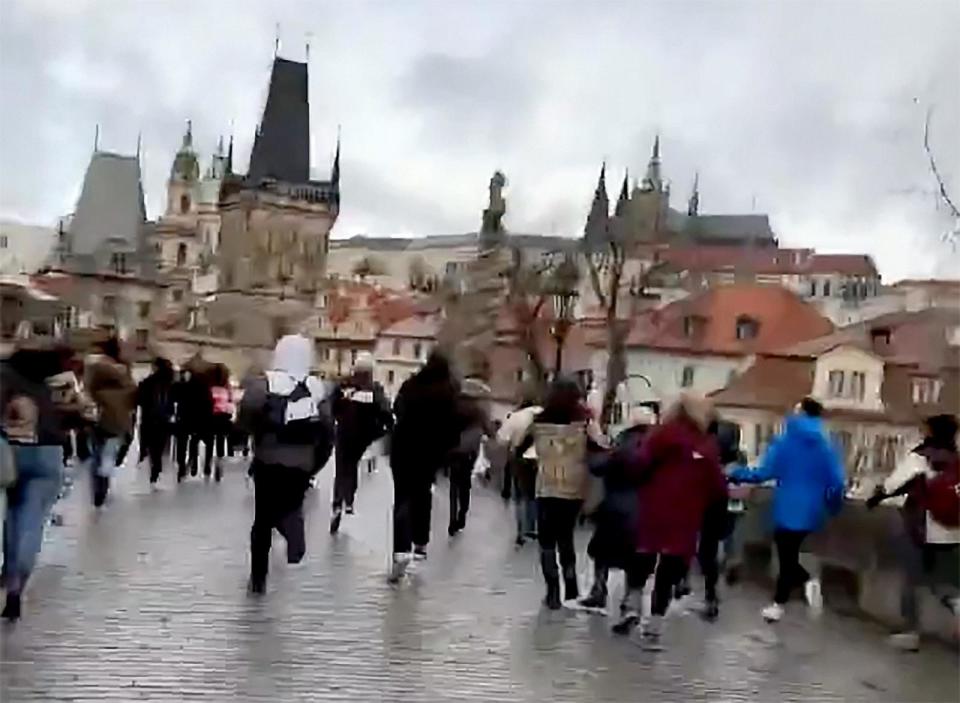 PHOTO: People run from the scene of a shooting in downtown Prague, Czech Republic, Dec. 21, 2023. (Leo Menindez)