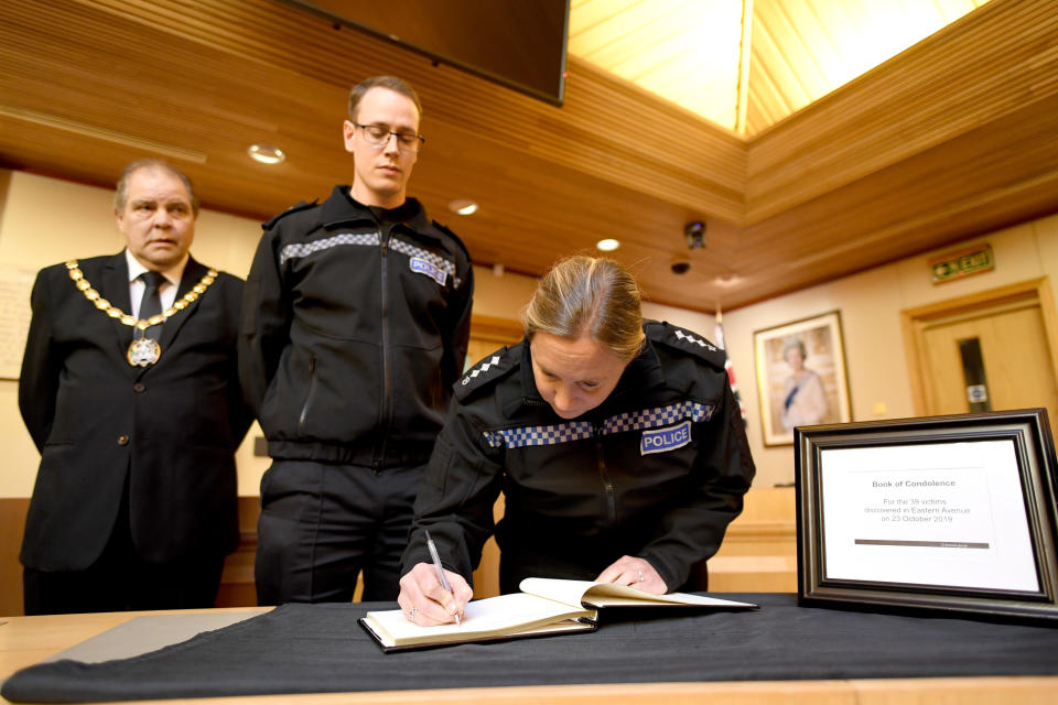 (left to right) Mayor of Thurrock Terry Piccolo, Superintendent Craig Saunders and Chief Inspector Claire Talbot (both of Essex Police) sign the Book of Condolence in the Council Chamber of Thurrock Council in Grays, Essex, after 39 bodies were found inside a lorry at Waterglade Industrial Park in Grays, Essex, on Wednesday.