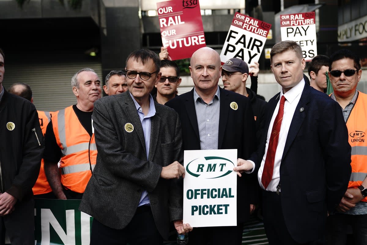 General Secretary Mick Lynch (centre) and Eddie Dempsey (right), Assistant General Secretary, of the Rail, Maritime and Transport union (RMT), outside London Euston train station as union members take part in a fresh strike over jobs, pay and conditions (Aaron Chown/PA) (PA Wire)