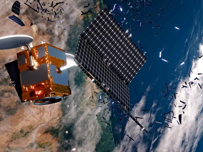 illustration shows satellite shedding bits of metal debris high above earth