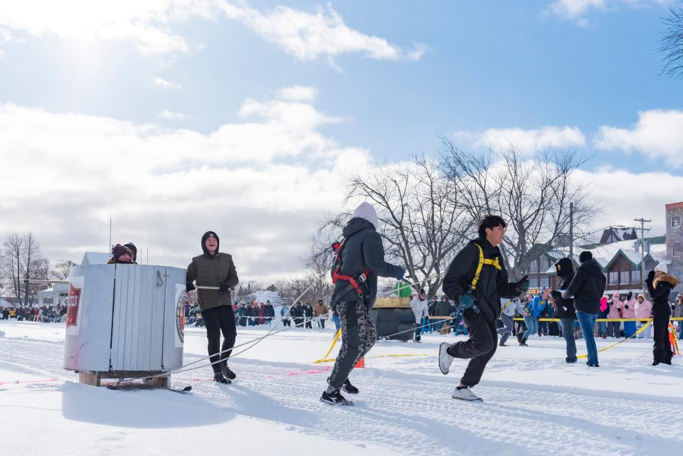 Team "The Dixie Saloon" crosses the finish line during the annual Outhouse Races as part of the Mackinaw City Winterfest in the Shepler's Ferry parking lot on Saturday, Jan. 20, 2024.