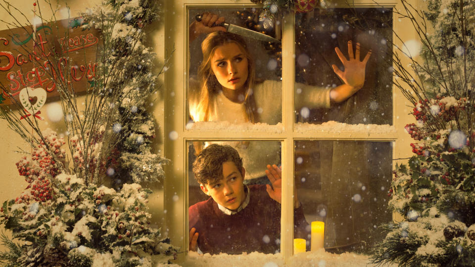 Olivia DeJonge and Levi Miller looking out a window