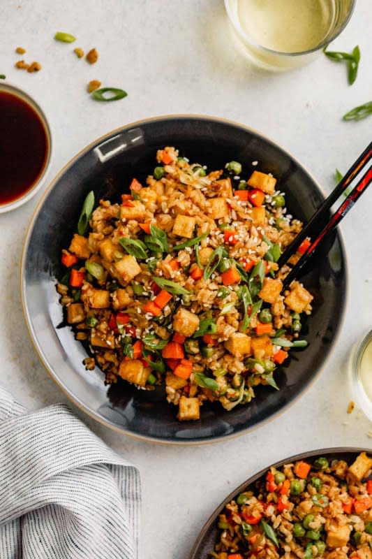 <p>Zestful Kitchen</p><p>This vegan fried rice recipe is the perfect weeknight dinner! Easy, healthy and so satisfying. It's full of plant-based protein thanks to oven-baked tofu, tons of veggies and even whole-grain brown rice.</p><p><strong>Get the recipe: <a href="https://zestfulkitchen.com/vegan-tofu-fried-rice-recipe/" rel="nofollow noopener" target="_blank" data-ylk="slk:Vegan Tofu Fried Brown Rice;elm:context_link;itc:0;sec:content-canvas" class="link rapid-noclick-resp">Vegan Tofu Fried Brown Rice</a></strong></p>