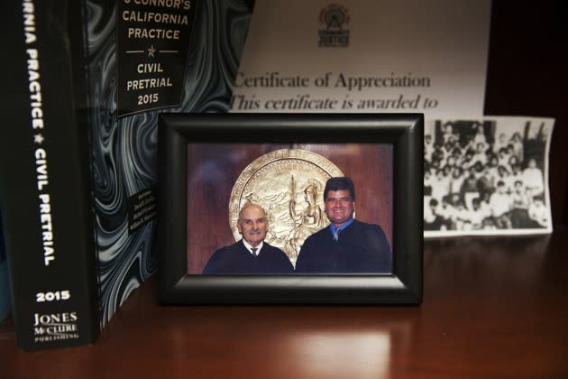 A picture of Perez with his father, who is also a judge, in his office. (Emily Berl / The Atlantic)