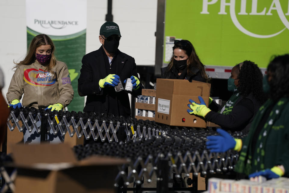 President-elect Joe Biden participates in a National Day of Service event at Philabundance, a hunger relief organization, with his daughter Ashley Biden, and his granddaughter Finnegan Biden, left, Monday, Jan. 18, 2021, in Philadelphia. (AP Photo/Evan Vucci)