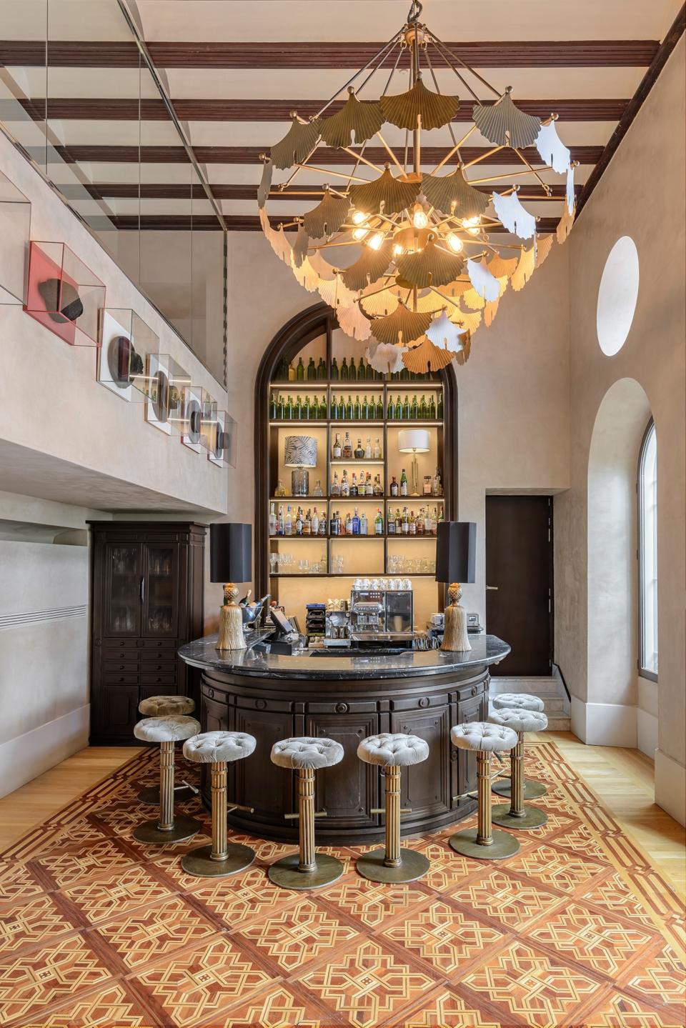 The archway in black behind a bar in white and gold.