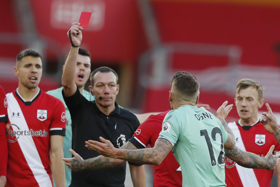Everton's Lucas Digne, centre right, is shown a red card by the referee after a foul on Southampton's Kyle Walker-Peters during an English Premier League soccer match between Southampton and Everton at the St. Mary's stadium in Southampton, England, Sunday Oct. 25, 2020. (AP Photo/Frank Augstein, Pool)