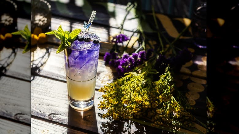 Purple cocktail with mint garnish
