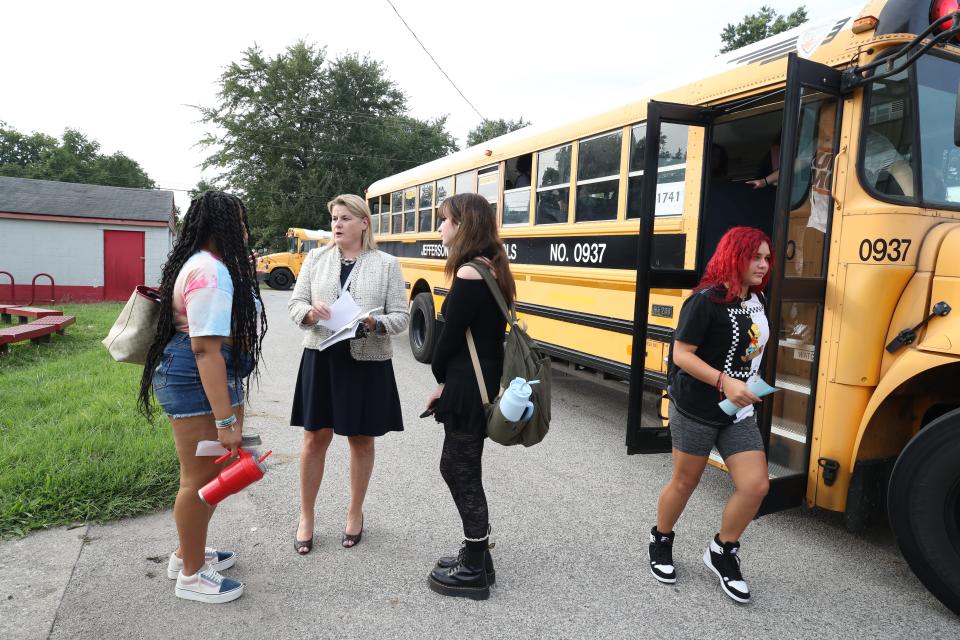 Waggener High School principal Sarah Hutchings helps students find their way after the last bus arrived at the school on Monday, August 21, 203