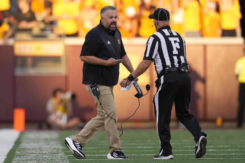 Nebraska coach Matt Rhule, left, reacts to an official during the first half of the team's NCAA college football game against Minnesota, Thursday, Aug. 31, 2023, in Minneapolis. (AP Photo/Abbie Parr)