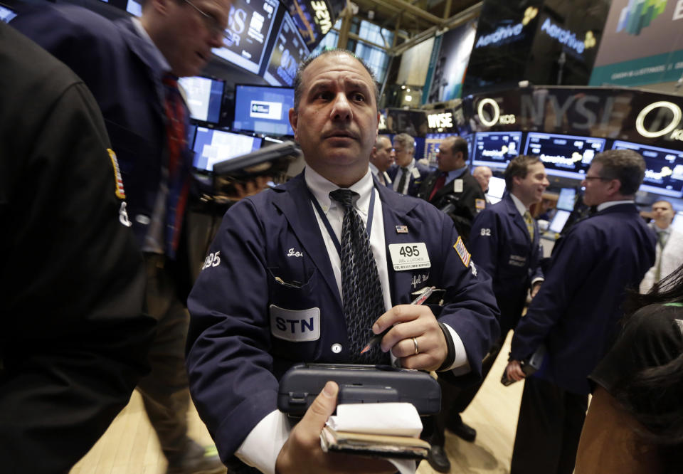 Trader Joel Luccese, center, works on the floor of the New York Stock Exchange Friday, March 28, 2014. After two days of declines, stocks were moving higher in early trading Friday following news that U.S. consumer spending rose the most in three months in February. (AP Photo/Richard Drew)