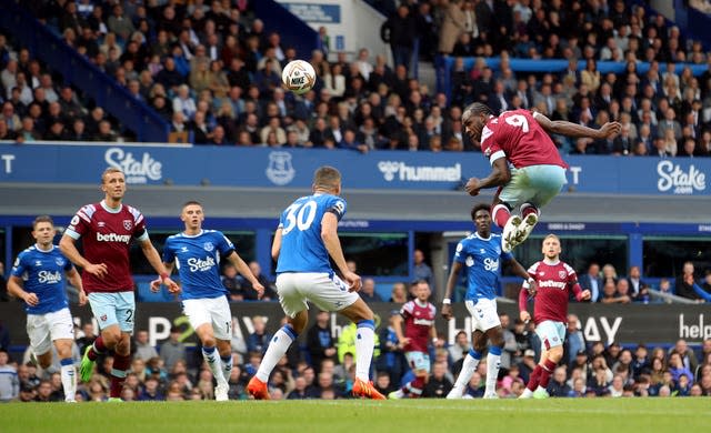 West Ham's Michail Antonio, right, gets up high to head at goal against Everton