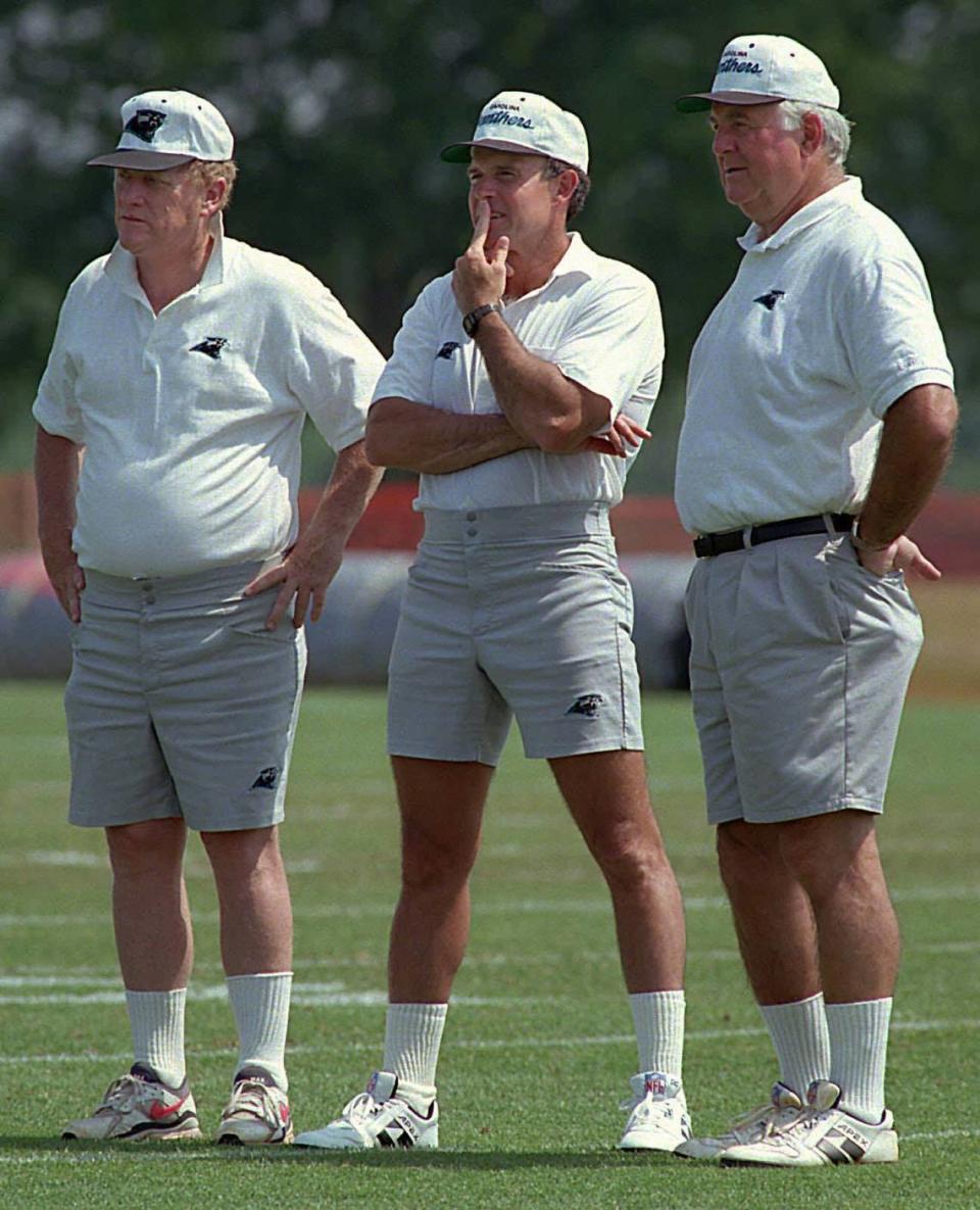 In June 1995, the braintrust for the first-ever Carolina Panthers team huddled following a practice. From left to right: general manager Bill Polian, head coach Dom Capers and team president Mike McCormack.