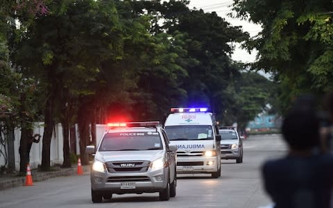 An ambulance transporting alleged members of the children's football team approaches the hospital  - Credit: LILLIAN SUWANRUMPHA /AFP