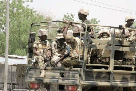 Soldiers are seen on a truck in Maiduguri in Borno State, Nigeria May 14, 2015. REUTERS/Stringer