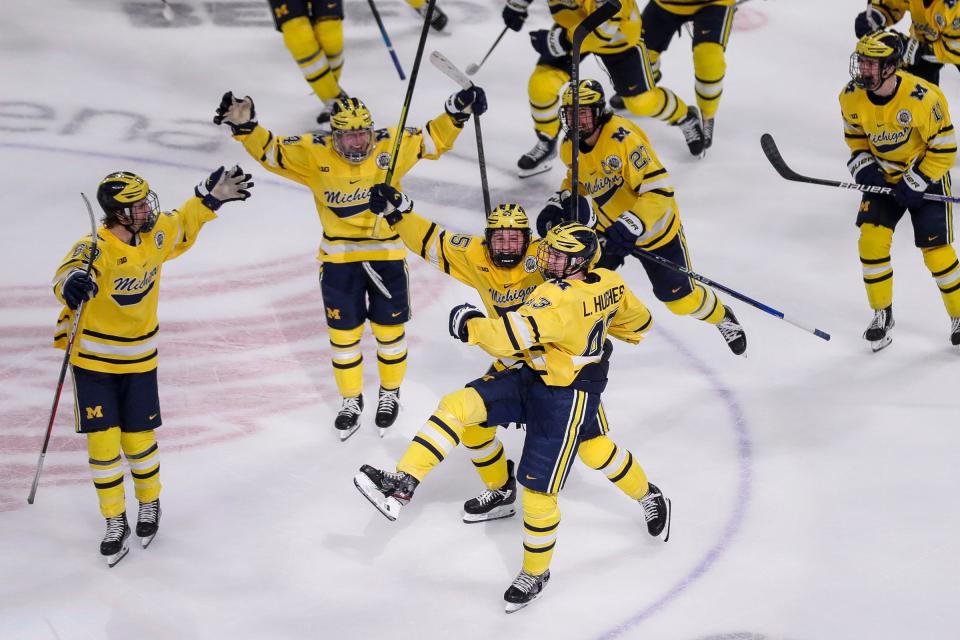 Michigan defenseman Luke Hughes (43) celebrates a goal against Michigan State during overtime of the "Duel in the D" at Little Caesars Arena in Detroit on Saturday, Feb. 11, 2023.
