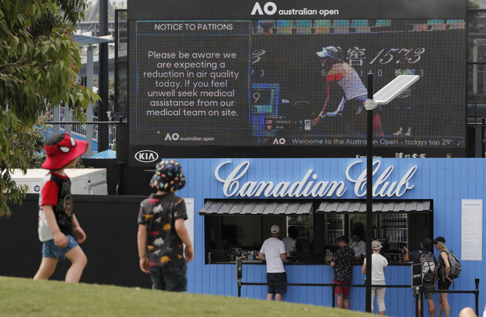 A sign warns spectators of air quality ahead of the Australian Open tennis championship in Melbourne, Australia, Saturday, Jan. 18, 2020. (AP Photo/Lee Jin-man)