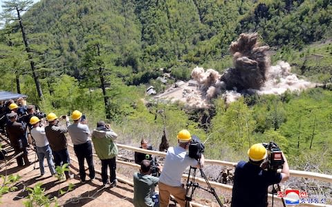 Journalists watch as North Korea's nuclear test site is dismantled - Credit: KCNA