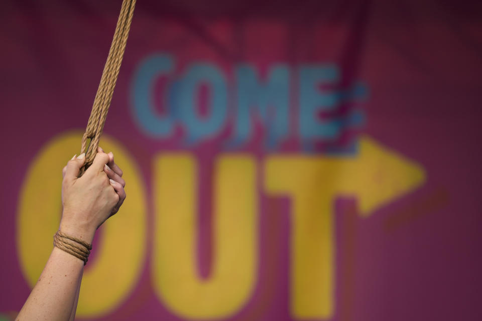 Actress Cabiria Morgernstern performs at Pride Park, a venue for artistic shows ahead the Pride 2021 in Bucharest, Romania, Thursday, Aug. 12, 2021. The 20th anniversary of the abolishment of Article 200, which authorized prison sentences of up to five years for same-sex relations, was one cause for celebration during the gay pride parade and festival held in Romania's capital this month. People danced, waved rainbow flags and watched performances at Bucharest Pride 2021, an event that would have been unimaginable a generation earlier. (AP Photo/Vadim Ghirda)