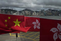 FILE - Chinese and Hong Kong flags are hanged to celebrate the 25th anniversary of Hong Kong handover to China, in Hong Kong, Friday, June 17, 2022. Hong Kong authorities, citing “security reasons,” have barred more than 10 journalists from covering events and ceremonies this week marking the 25th anniversary of Hong Kong’s return to China, according to the Hong Kong Journalists Association, Tuesday, June 28, 2022. (AP Photo/Kin Cheung, File)