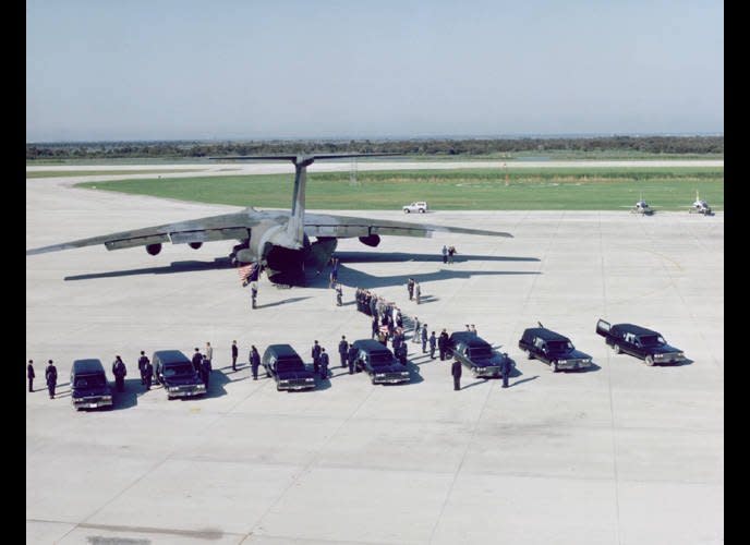 The Challenger crewmember remains are being transferred from 7 hearse vehicles to a MAC C-141 transport plane at the Kennedy Space Center's Shuttle Landing Facility for transport to Dover Air Force Base, Delaware. (NASA-JSC, Aug. 30, 1988) (<a href="http://history1900s.about.com/od/photographs/ig/Space-Shuttle-Challenger/" target="_hplink">Via About.com</a>)