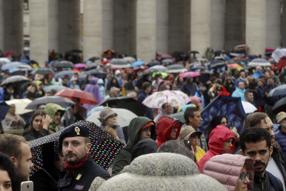 In this Sunday, Nov. 4, 2018, photo an Italian policeman patrols in a faithful crowded St. Peter's Square during Pope Francis' Angelus noon prayer at the Vatican. Synagogues, mosques, churches and other houses of worship are routinely at risk of attack in many parts of the world. And so worshippers themselves often feel the need for visible, tangible protection even as they seek the divine. (AP Photo/Gregorio Borgia)