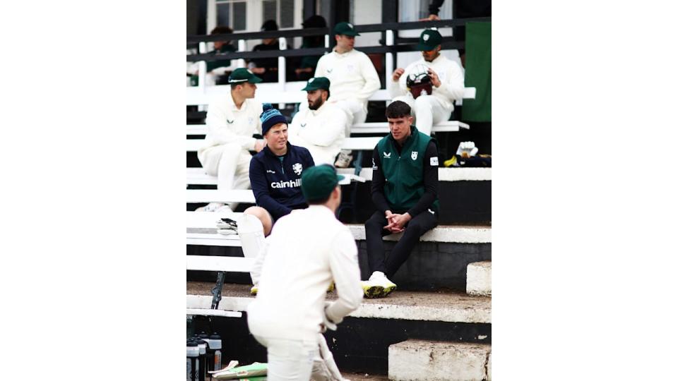 Josh Baker sat with members of his cricket club