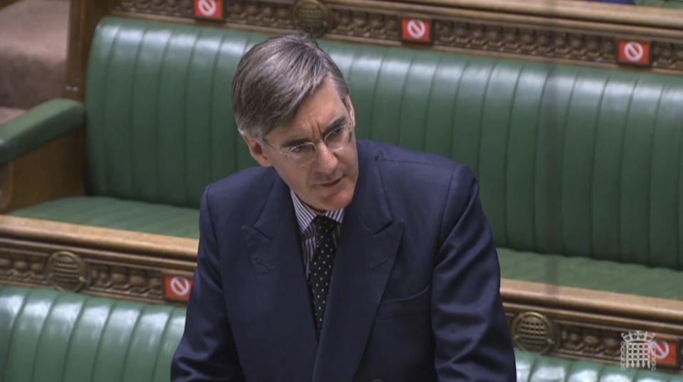 In this grab taken from video provided by the House of Commons, Leader of the House Jacob Rees Mogg answers questions in the House of Commons, during a motion on parliamentary proceedings during the coronavirus outbreak, in London, Tuesday June 2, 2020. Like many other Britons, U.K. lawmakers have largely been working from home during the coronavirus pandemic. Now they are being summoned back to the office and many aren’t happy. They say the government’s decision to scrap a remote-voting system used during the pandemic will turn those who must stay home because of age, illness or family issues into second-class lawmakers. (House of Commons via AP)