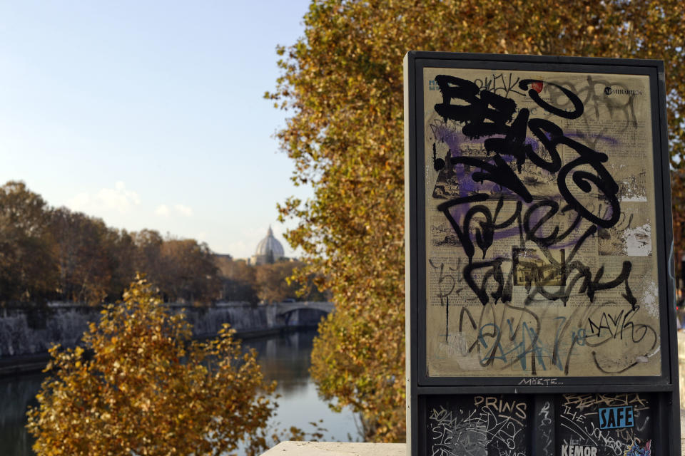 A tourist information board is scribbled in graffiti as it overlooks the Tiber River and St. Peter's Dome, in downtown Rome, Thursday, Nov. 15, 2018. Rome’s monumental problems of garbage and decay exist side-by-side with Eternal City’s glories. (AP Photo/Gregorio Borgia)