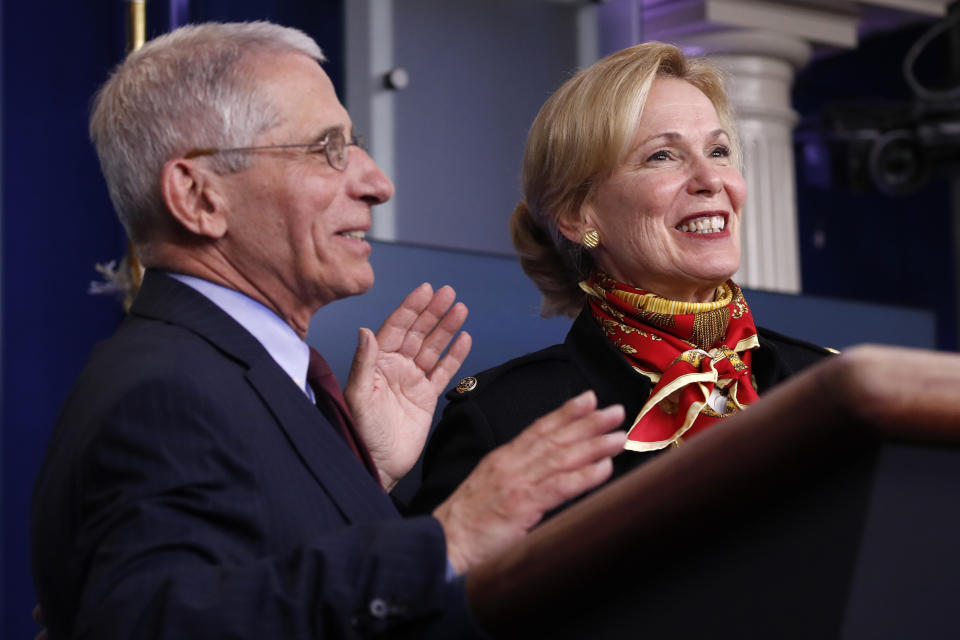 Dr. Anthony Fauci, director of the National Institute of Allergy and Infectious Diseases, and Dr. Deborah Birx, White House coronavirus response coordinator, smile as they decide who is going to answer a question during a briefing about the coronavirus in the James Brady Press Briefing Room of the White House, Tuesday, March 31, 2020, in Washington. (AP Photo/Alex Brandon)