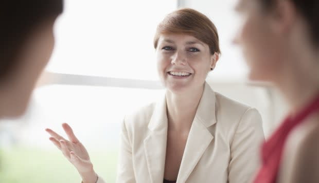 Smiling businesswoman talking to her colleagues