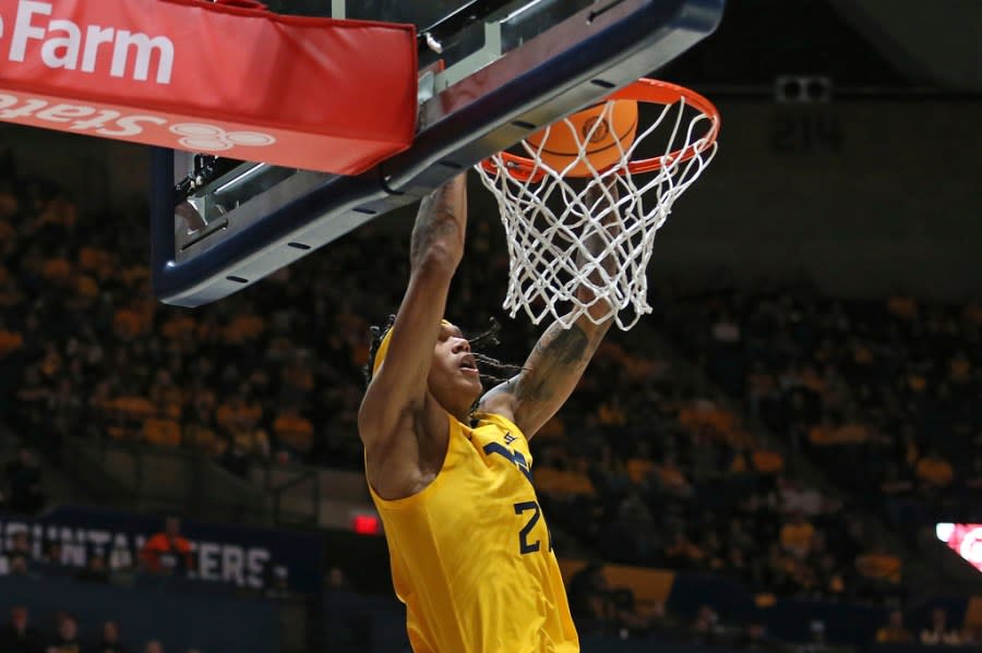 West Virginia guard RaeQuan Battle (21) shoots against Texas during the second half of an NCAA college basketball game on Saturday, Jan. 13, 2024, in Morgantown, W.Va. (AP Photo/Kathleen Batten)